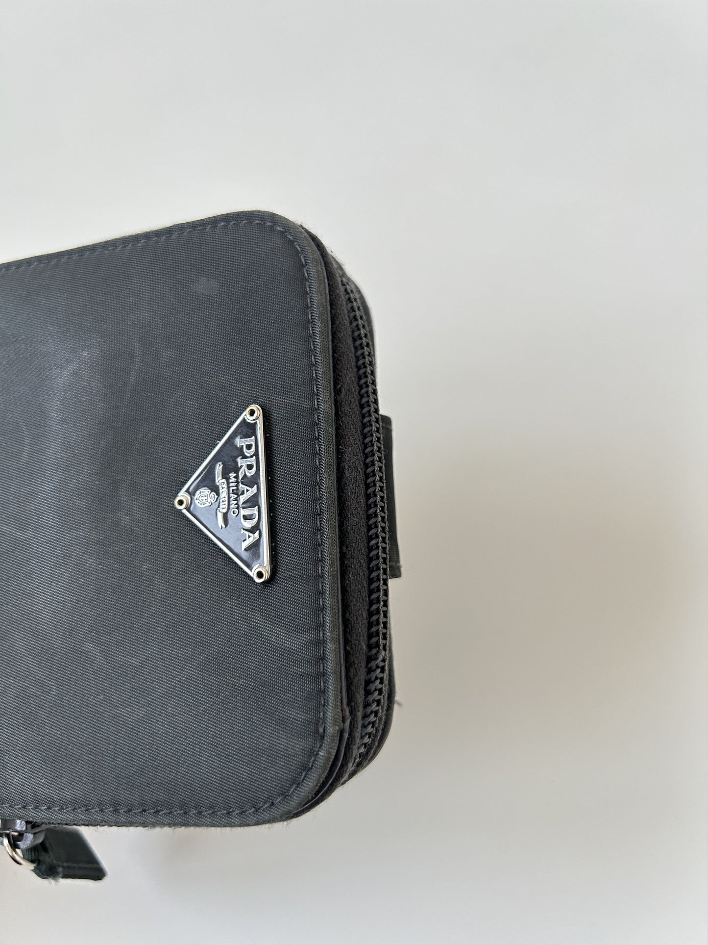 Prada nylon and saffiano leather triangle logo zip wallet