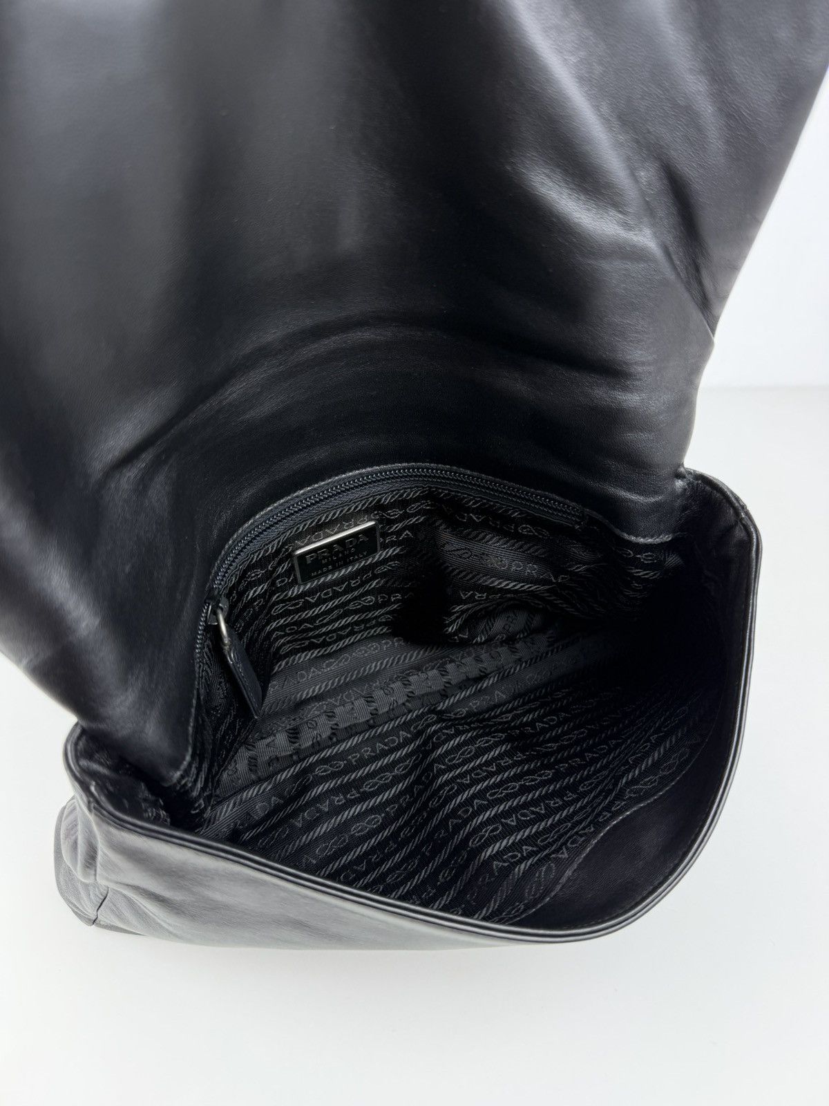 Vintage Prada embossed logo leather shoulder bag