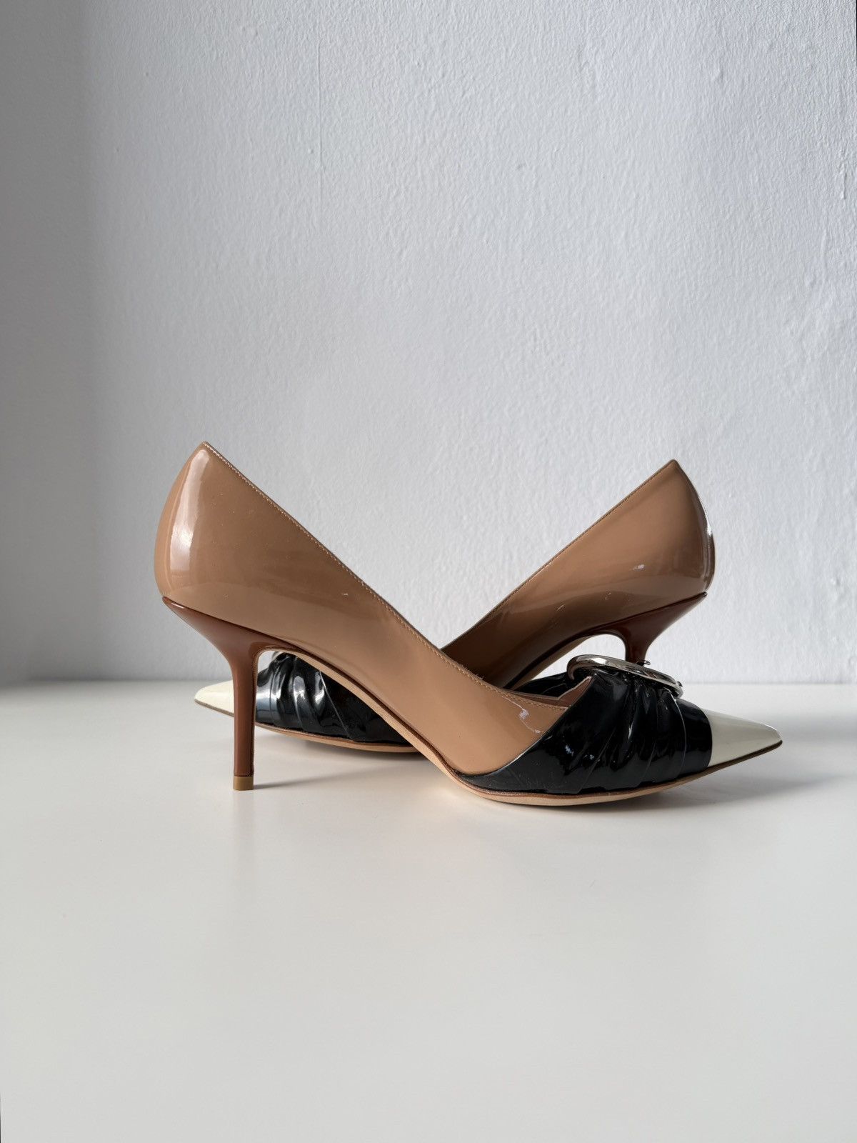 Dior patent leather buckled pointed toe pumps with bow